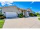 White two-car garage with landscaping at 265 Belvedere Ct, Punta Gorda, FL 33950