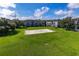 Sand volleyball court surrounded by lush green grass at 12904 Sanctuary Cove Dr # 301, Temple Terrace, FL 33637