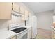 Well-equipped kitchen boasting a smooth-top range and overhead cabinets at 12904 Sanctuary Cove Dr # 301, Temple Terrace, FL 33637