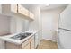 Modern kitchen with white cabinetry and wood flooring at 12904 Sanctuary Cove Dr # 301, Temple Terrace, FL 33637