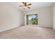 Spacious bedroom with carpeted floors and sliding door to balcony at 12904 Sanctuary Cove Dr # 301, Temple Terrace, FL 33637