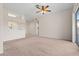 Bright living room with neutral carpeting and access to kitchen at 12904 Sanctuary Cove Dr # 301, Temple Terrace, FL 33637