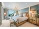 Luxurious main bedroom with large bed, ocean view, and sitting area at 2251 Gulf Of Mexico Dr # 203, Longboat Key, FL 34228