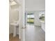 Bright bathroom boasts a pedestal sink, oval mirror, and modern fixtures, offering a clean and inviting space at 168 Lazy Shore Dr, Nokomis, FL 34275