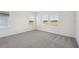 Spacious bedroom with three windows and grey carpet at 168 Lazy Shore Dr, Nokomis, FL 34275
