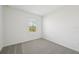 Well-lit bedroom featuring grey carpet and a window at 168 Lazy Shore Dr, Nokomis, FL 34275