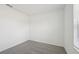 Bright bedroom with grey carpet, large closet, and window with blinds at 168 Lazy Shore Dr, Nokomis, FL 34275