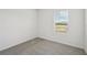 Simple bedroom with grey carpet and window with blinds at 168 Lazy Shore Dr, Nokomis, FL 34275