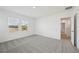 Large bedroom with grey carpet and access to hallway at 168 Lazy Shore Dr, Nokomis, FL 34275