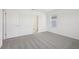 Bright bedroom with grey carpet and access to bathroom at 168 Lazy Shore Dr, Nokomis, FL 34275