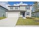 Two-story house with white garage door and gray siding at 168 Lazy Shore Dr, Nokomis, FL 34275