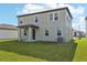 Two-story house exterior showcasing gray siding, windows, and a backyard at 168 Lazy Shore Dr, Nokomis, FL 34275