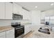 Bright kitchen features stainless steel appliances, granite countertops, and white cabinetry at 168 Lazy Shore Dr, Nokomis, FL 34275