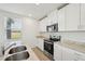 Modern kitchen featuring stainless steel appliances and granite countertops at 168 Lazy Shore Dr, Nokomis, FL 34275