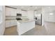 Modern kitchen with white cabinets, granite counters, and island at 168 Lazy Shore Dr, Nokomis, FL 34275