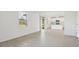 Bright living room with gray tile floors and sliding glass door at 168 Lazy Shore Dr, Nokomis, FL 34275