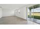 Living room with gray tile floors and sliding glass doors at 168 Lazy Shore Dr, Nokomis, FL 34275
