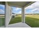 Covered patio offers outdoor living space overlooking the spacious backyard and green space at 168 Lazy Shore Dr, Nokomis, FL 34275
