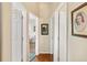 Bright hallway with wood floors and access to bedrooms at 7319 Eleanor Cir, Sarasota, FL 34243