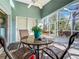 Relaxing screened lanai with patio furniture and lush landscaping views at 7319 Eleanor Cir, Sarasota, FL 34243