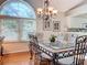 Elegant dining room featuring a marble-top table and arched window at 7319 Eleanor Cir, Sarasota, FL 34243
