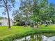 Peaceful backyard oasis with pond view and lush landscaping at 7319 Eleanor Cir, Sarasota, FL 34243