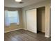 Bright bedroom with large closet and wood-look flooring at 624 Golden Raintree Pl # 624, Brandon, FL 33510