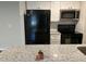 Modern kitchen with granite countertop and black appliances at 624 Golden Raintree Pl # 624, Brandon, FL 33510