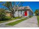 Tan brick house with red door and a driveway at 4701 13Th S Ave, St Petersburg, FL 33711