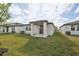 Landscaped backyard with covered patio and grassy area at 113 Whiteland Bnd, Nokomis, FL 34275