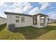 Covered patio and grassy backyard with AC unit at 113 Whiteland Bnd, Nokomis, FL 34275