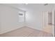 Bright bedroom with carpeted floor, window with blinds, and access to a bathroom at 113 Whiteland Bnd, Nokomis, FL 34275