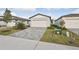 New home with gray exterior, paver driveway, and landscaping at 113 Whiteland Bnd, Nokomis, FL 34275