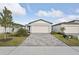 New construction home with gray exterior, paver driveway, and landscaping at 113 Whiteland Bnd, Nokomis, FL 34275