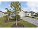 House exterior showcasing landscaping and paver driveway at 113 Whiteland Bnd, Nokomis, FL 34275