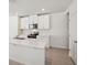 Modern kitchen boasts white cabinets, stainless steel appliances, and a large island at 113 Whiteland Bnd, Nokomis, FL 34275