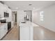 Open concept kitchen with island and stainless steel appliances at 113 Whiteland Bnd, Nokomis, FL 34275