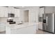 Modern kitchen with stainless steel appliances and white cabinets at 113 Whiteland Bnd, Nokomis, FL 34275