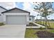 Single-story home with gray garage door and landscaped walkway at 456 Lazy Shore Dr, Nokomis, FL 34275