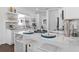 Modern kitchen with white cabinets, marble countertops, and stainless steel appliances at 1101 22Nd N Ave, St Petersburg, FL 33704