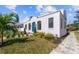 Charming Spanish-style home with a blue door and landscaped yard at 1101 22Nd N Ave, St Petersburg, FL 33704