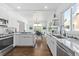 Modern kitchen with island, white cabinets, and hardwood floors at 1101 22Nd N Ave, St Petersburg, FL 33704