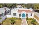 White stucco house with terracotta roof, blue door, and landscaped yard at 1101 22Nd N Ave, St Petersburg, FL 33704