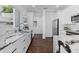 Modern kitchen with white cabinets, marble countertops, and stainless steel appliances at 1101 22Nd N Ave, St Petersburg, FL 33704