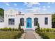 White Spanish-style home with a teal front door at 1101 22Nd N Ave, St Petersburg, FL 33704