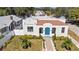 White stucco house with terracotta roof, blue door, and landscaped yard at 1101 22Nd N Ave, St Petersburg, FL 33704