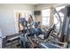 Bright home gym featuring modern fitness equipment and natural light from large windows at 8493 Hardy Bay Loop, Wesley Chapel, FL 33545