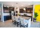 Stylish kitchen featuring dark cabinetry, granite countertops, and a central island with seating at 8493 Hardy Bay Loop, Wesley Chapel, FL 33545