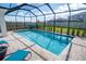 Screened-in pool with clear blue water and paved deck offers a refreshing outdoor retreat at 8493 Hardy Bay Loop, Wesley Chapel, FL 33545