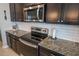 Kitchen with granite countertops, stainless steel appliances, and white backsplash at 8493 Hardy Bay Loop, Wesley Chapel, FL 33545